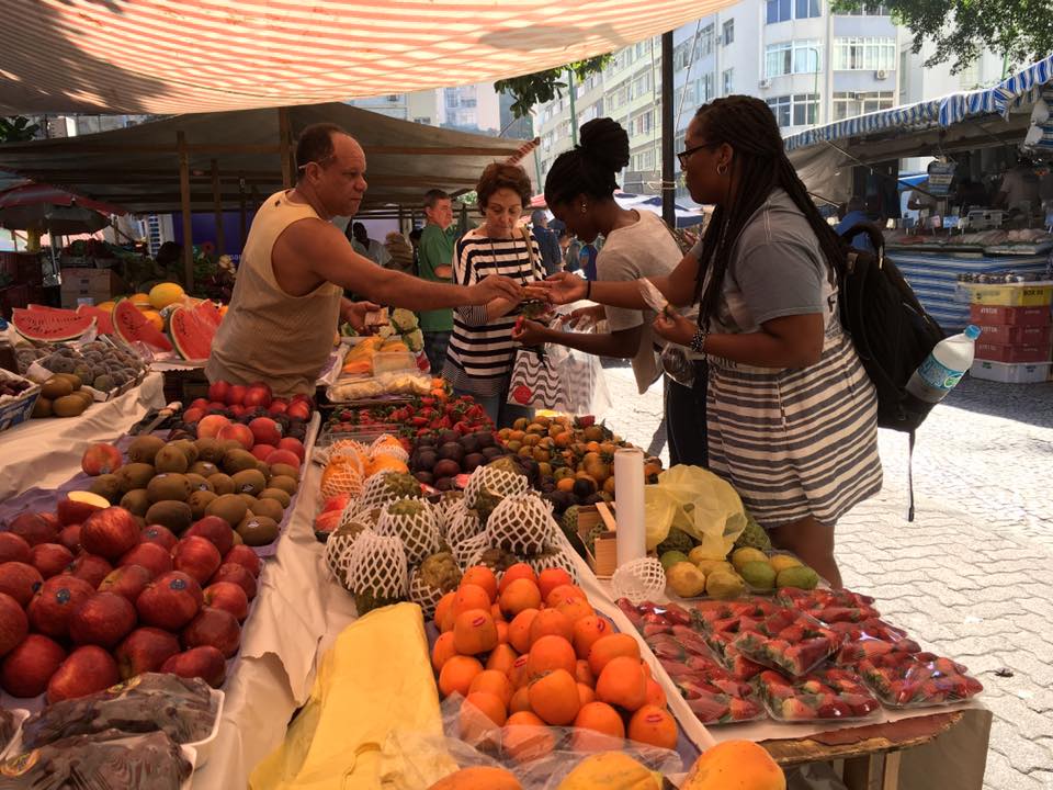 test-tasting fruits at a local farmers' market