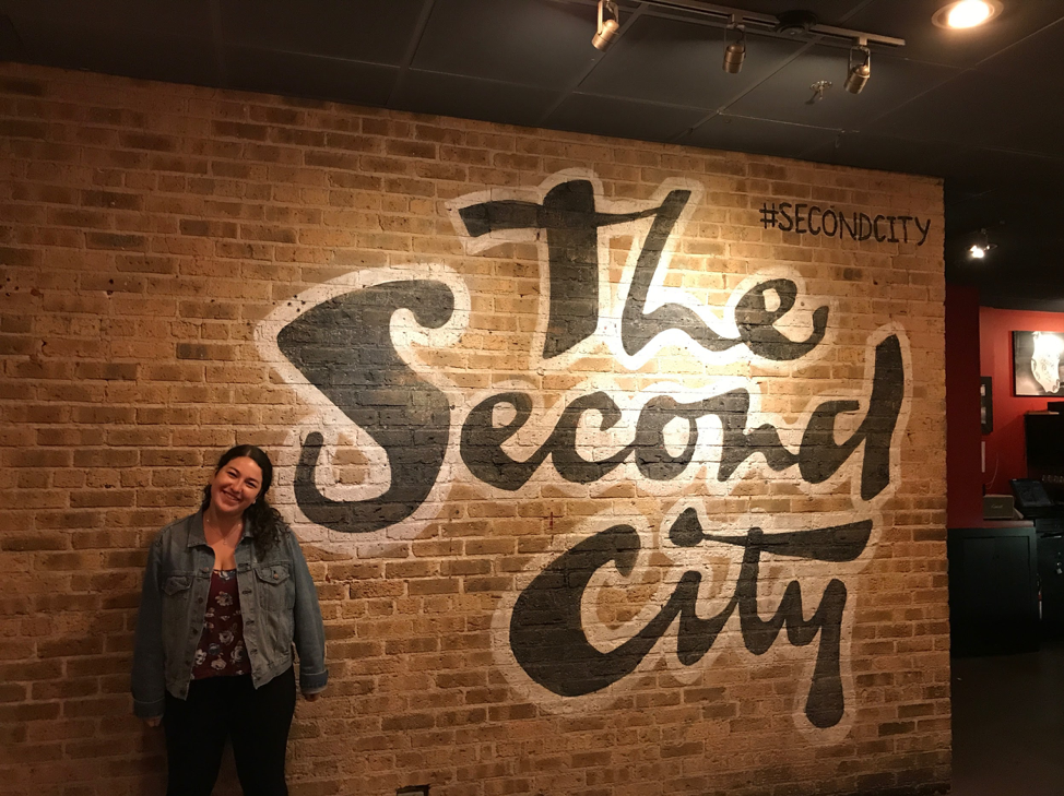 Shaina posing outside of the main theater at The Second City, before watching a late night comedy show.