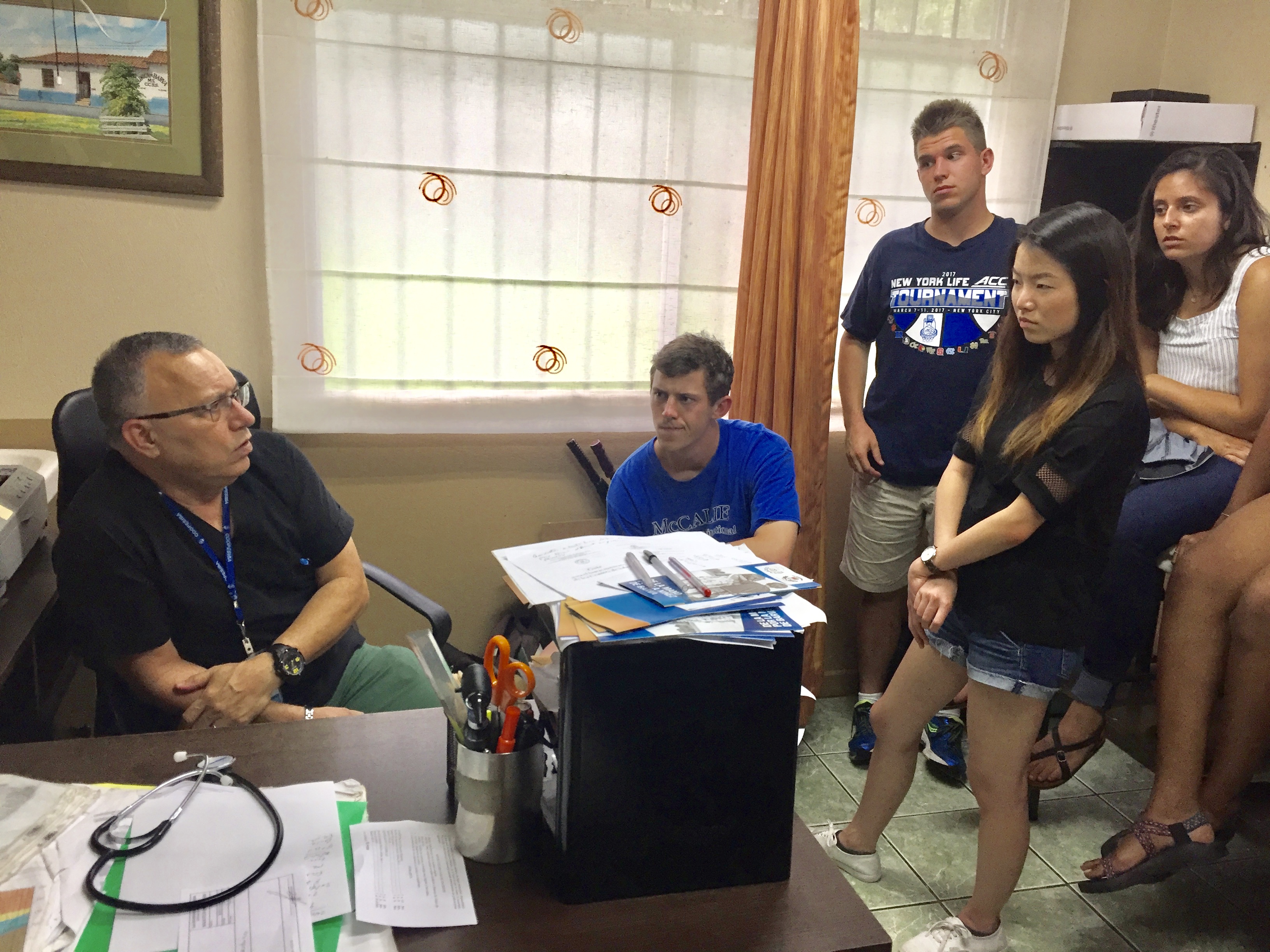 Photo of students meeting a doctor at an EBAIS, a local level clinical care facility.