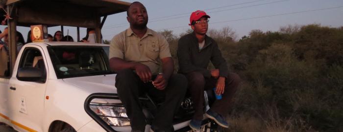 Photo of Niisoja Torto in South Africa on hood of vehicle