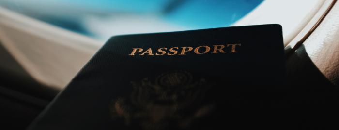 Passport lying in front of airplane window