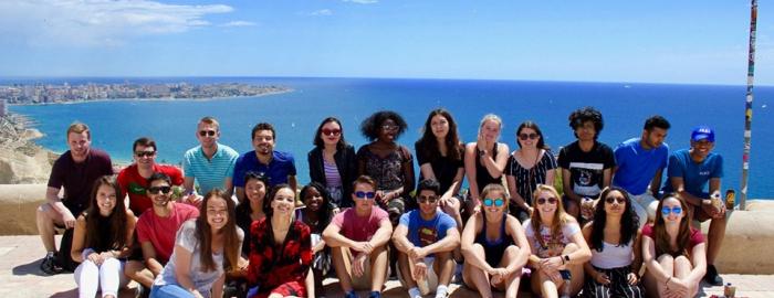 Duke in Alicante group photo standing in front of the water