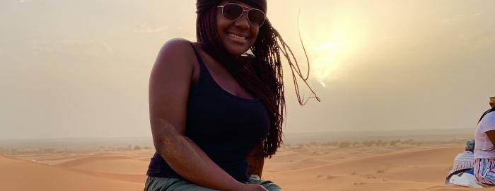 Raia Lockman sitting in a desert