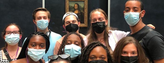 masked student in front of the mona lisa
