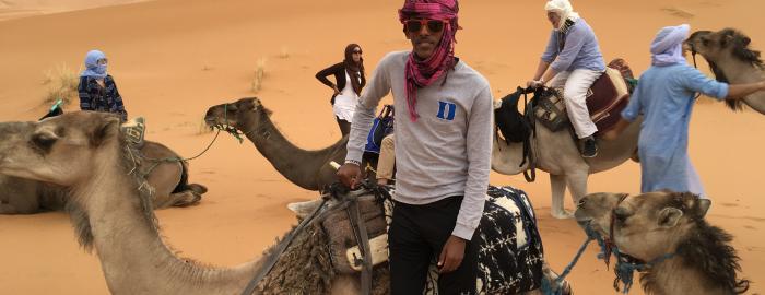 Riding camels in the Sahara Desert.